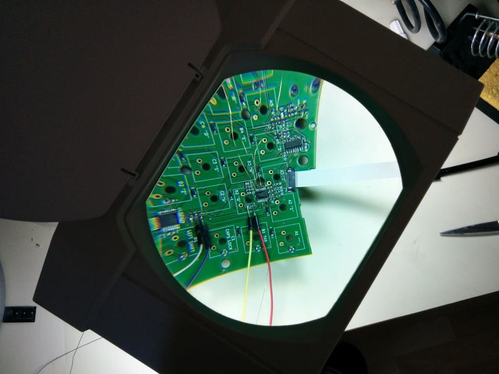 The newly soldered enamel wires under the magnifying lamp